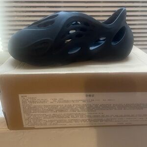 Yeezy foam indigo blue size 2. In great condition  used box included